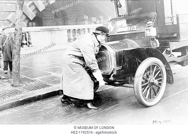 Driver Charlotte Marsh, who had been a suffragette, starting up a van, April 1915. This image was used to illustrate an article in the Suffragette newspaper...