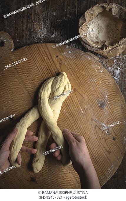 Challah bread (Jewish cuisine) being made: dough being plaited