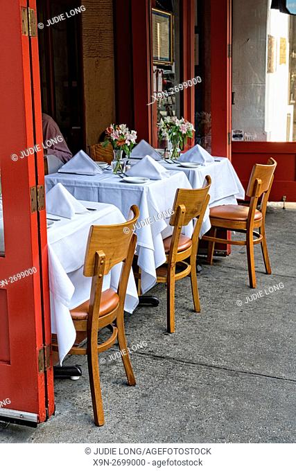 New York City, Manhattan, Upper East Side. View of Three Tables for Two at a Semi-Outdoor Restaurant Cafe