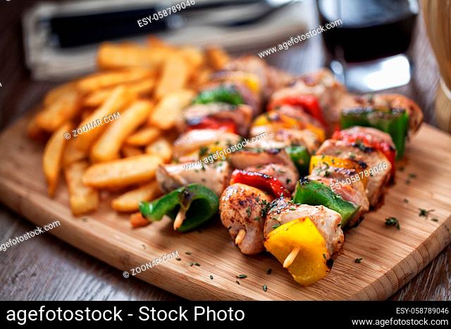 Chicken skewers with fries. High quality photo