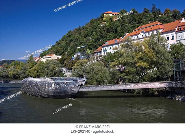 Murinsel is an artificial island on the Mur river, in the back is Schlossberg, Graz, Styria, Austria