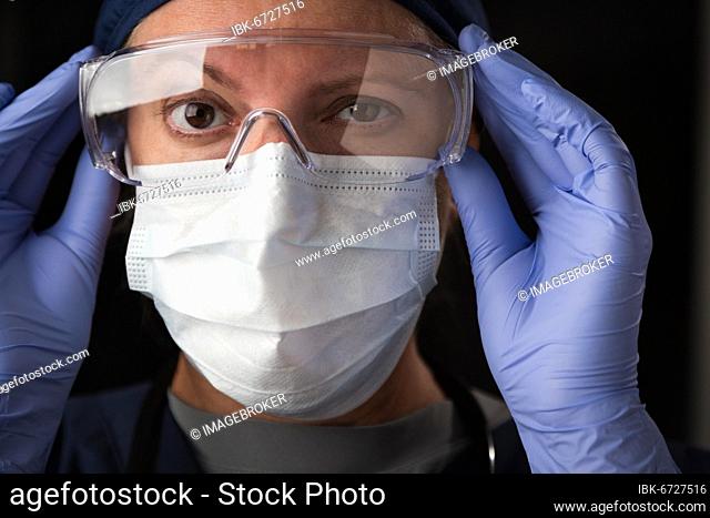 Close-Up of female doctor or nurse in medical face mask and protective gear