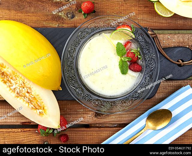 homemade yellow cantaloupe cream in glass plate with good table background