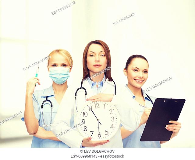 healthcare and medicine concept - calm female doctor and nurses with wall clock and stethoscope