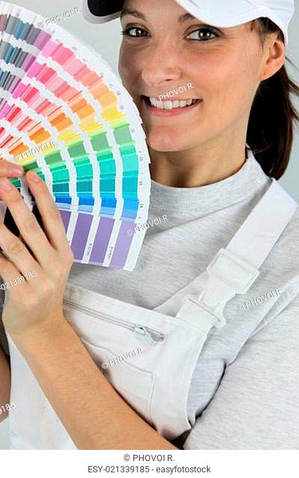 female painter holding a color chart