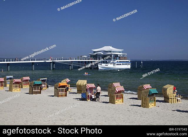 Beach chairs at Timmendorfer Strand with Seeschlösschenbrücke and Japanese teahouse, Lübeck Bay, Baltic Sea, Schleswig-Holstein, Germany, Europe