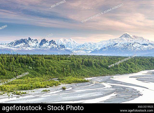 View of McKinley or Denali, Foraker and Hunter mounts behind Chulitna river from Parks Highway, Alaska, U. S. A