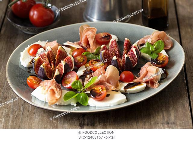 Tomato and mozzarella with figs and Serrano ham