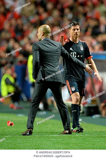 Munich's coach Josep ""Pep"" Guardiola (L) reacts after the substitution of Xabi Alonso during the UEFA Champions League quarterfinal second leg soccer match...