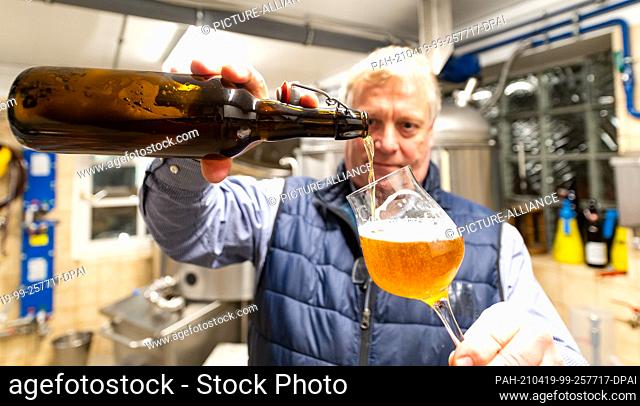 08 April 2021, Lower Saxony, Egestorf: Kai Beitzer controls his home-brewed beer. Kai Beitzer brews beer in an old slaughterhouse