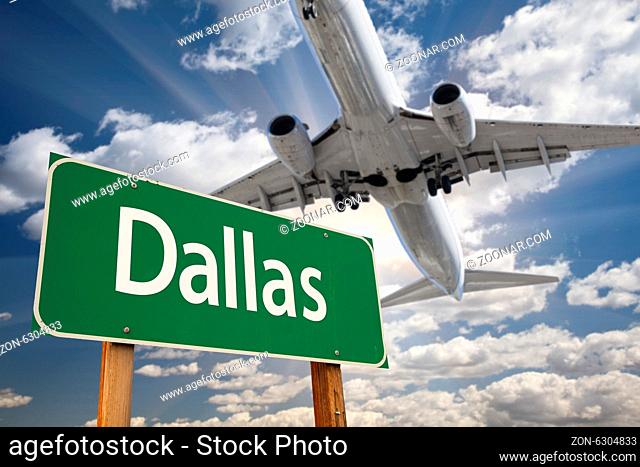 Dallas Green Road Sign and Airplane Above with Dramatic Blue Sky and Clouds