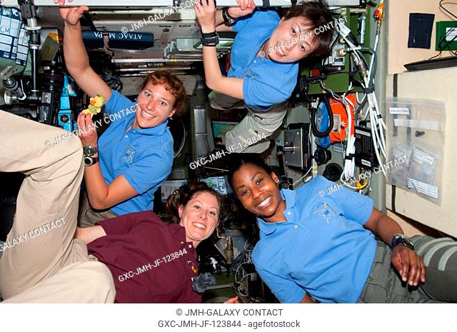 The four women currently on the International Space Station pose for a photo in the Zvezda Service Module while space shuttle Discovery remains docked with the...