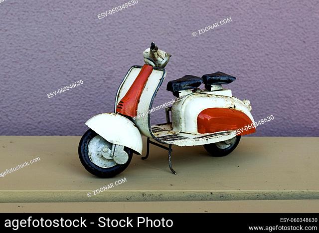 metal smaal decoration scooter on wooden shelf