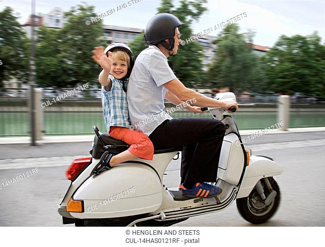 father and son on scooter