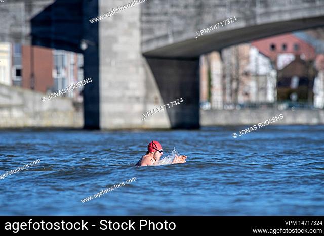 A participant is seen in the water during the 53th edition of the 'Traversee hivernale de la Meuse' winter swimming in the Meuse River, Sunday 27 February 2022
