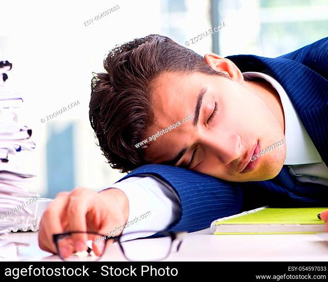 Tired businessman exhausted after hard work and excessive workload