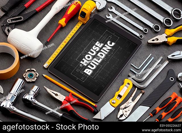 Tablet and tools with home under construction concept