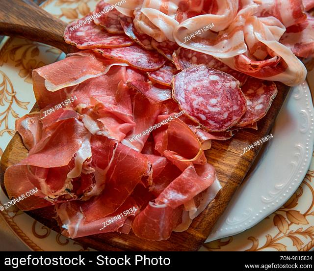 Typical various italian salami, servided on plate at restaurant