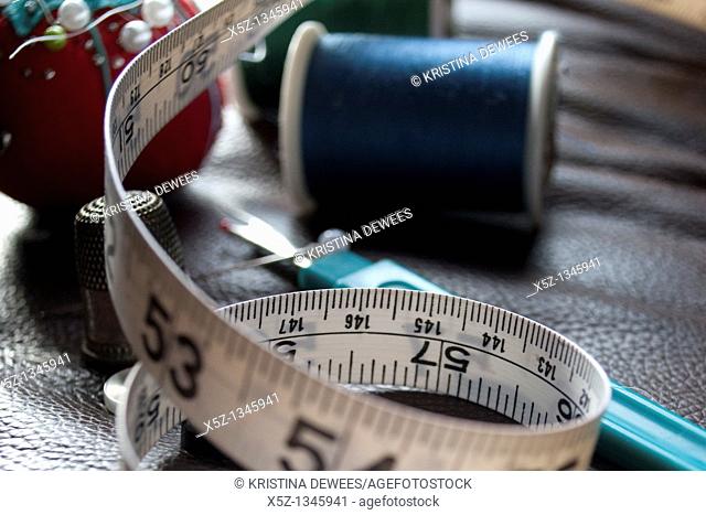 Some measuring tape and assorted sewing box items