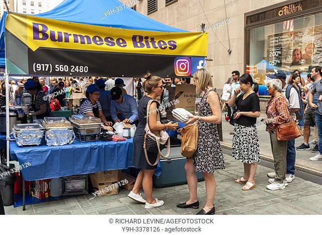 Tourists and office workers flock to Burmese Bites in The Outpost of the Queens Night Market, located in Rockefeller Plaza in New York on Tuesday, July 30, 2019