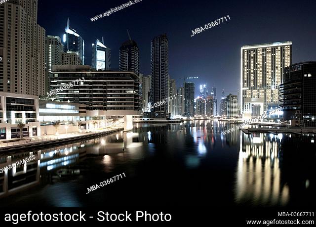 Skyscrapers in Dubai Marina and The Address Hotel at night with reflections, New Dubai, United Arab Emirates