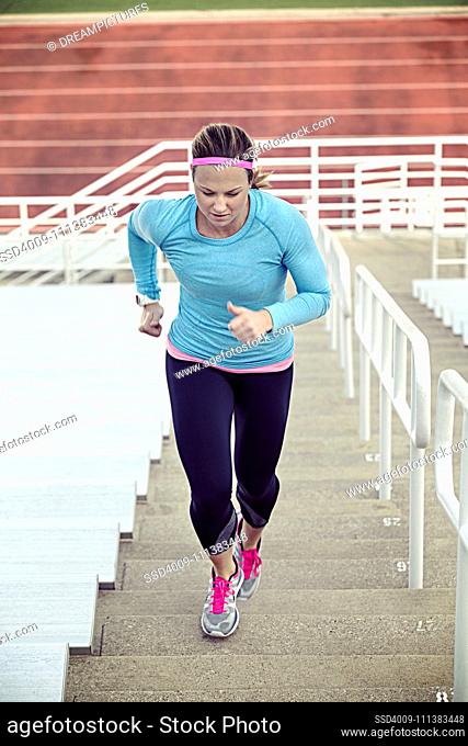 Caucasian athlete running up stairs