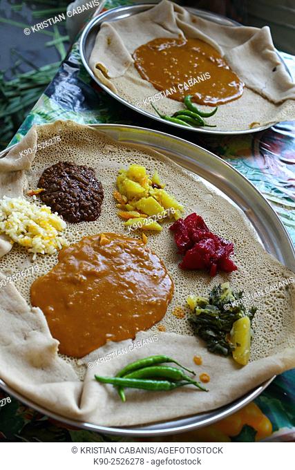 Injera made of tef and served on a big plate with different kinds of vegetables, Ethiopia, East Africa