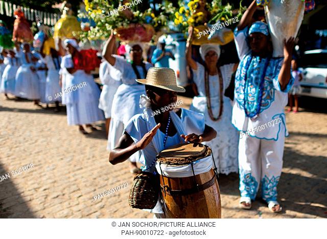 A young Cadomblefollower plays drum during the ritual procession in honor to Yemanya, the goddess of the sea, in Amoreiras, Bahia, Brazil, 3 February 2012