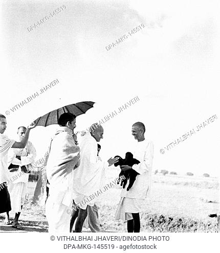 Mahatma Gandhi fondling a newborn two hours old goat carried by ashramite Balwant Singh , September 1938 NO MR