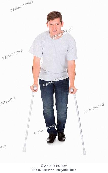 Young Man Walking With Two Crutches