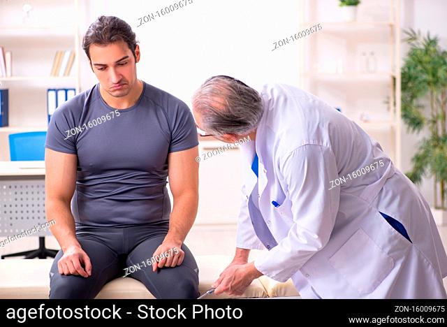 Young male patient visiting doctor traumatologist