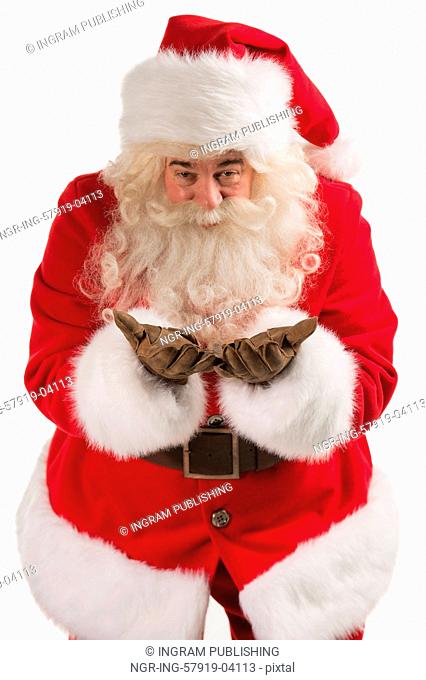 Portrait of Santa Claus sending an Air Kiss to camera. Blowing from arms