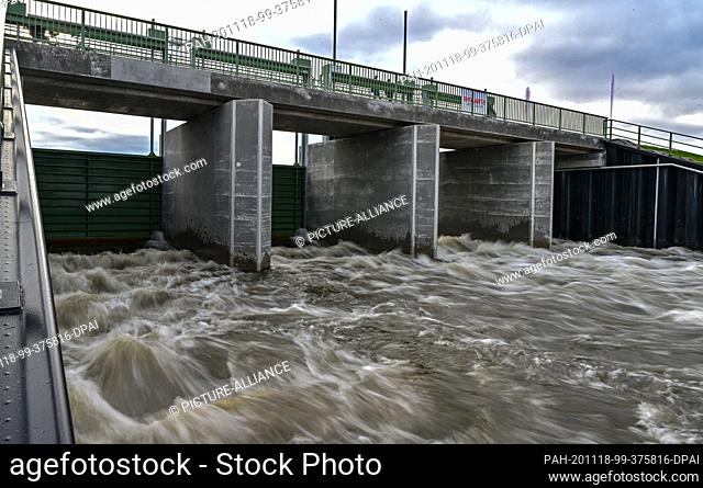18 November 2020, Brandenburg, Stützkow: Water from the German-Polish border river Oder flows through the new Oder inlet structure for the flooded polder in the...