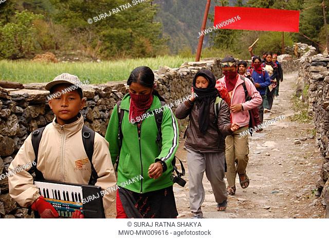 Young kids with their musical instruments arrive in a village to welcome a Maoist leader in Manang, Nepal April 25, 2007