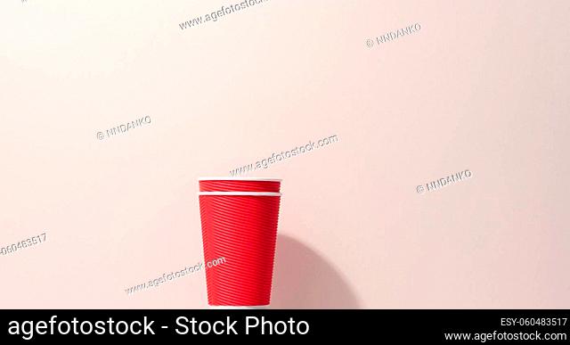 paper cardboard red cups for coffee, beige background. Eco-friendly tableware, zero waste