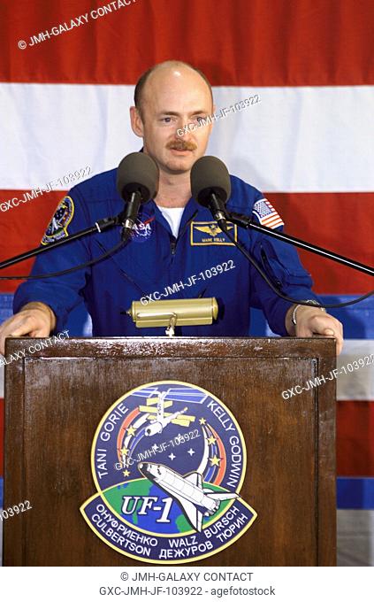 Astronaut Mark E. Kelly, STS-108 pilot, speaks from the podium in Hangar 990 at Ellington Field during the STS-108 and Expedition Three crew return ceremonies