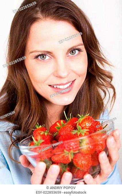 Woman enjoying a bowl of strawberries
