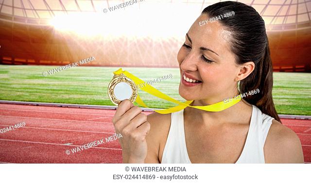 Composite image of female athlete posing with gold medals after victory