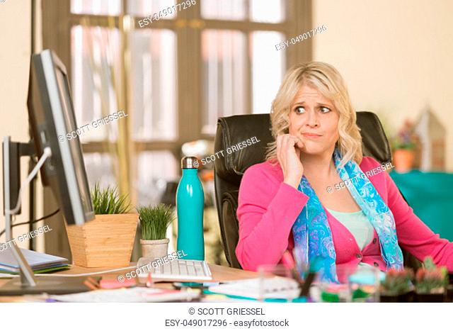Worried professional woman in her office