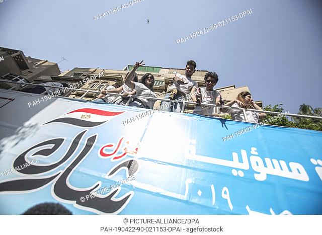 22 April 2019, Egypt, Cairo: Campaigners gesture on top of an open top campaign bus of the Mostaqbal Watan party on the third and last day of the national...