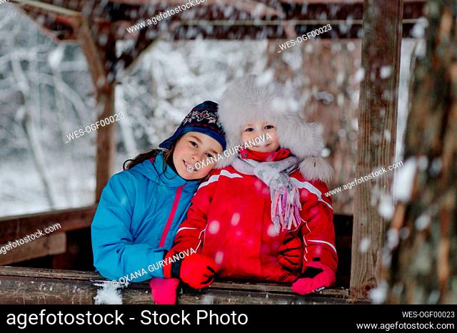 Portrait of two happy girls in winter clothes