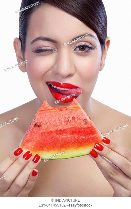 Portrait of a woman eating a watermelon