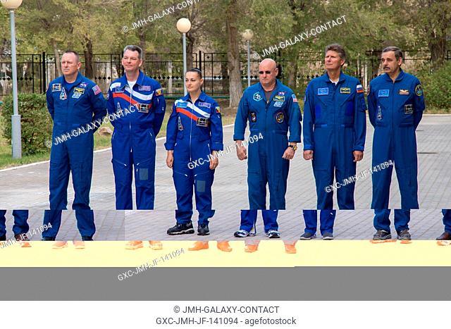 At their Cosmonaut Hotel crew quarters in Baikonur, Kazakhstan, the Expedition 4142 prime and backup crew members participate in ceremonies after raising the...