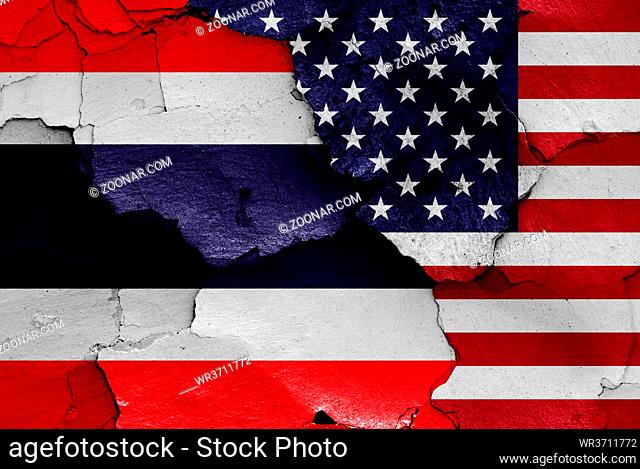 flags of Thailand and USA painted on cracked wall