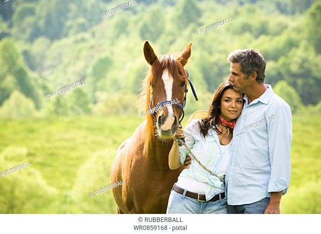 Mature man and a woman with a horse