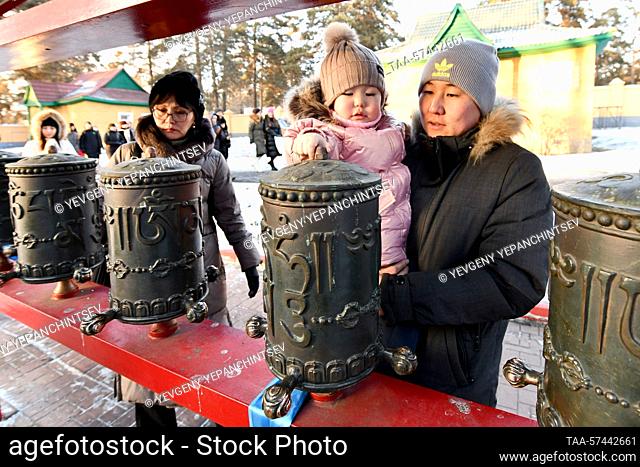 RUSSIA, CHITA - FEBRUARY 19, 2023: Buryat Buddhists are seen at prayer wheels before a purification ritual known as Dugzhuuba at Damba Braibunling Datsan on the...