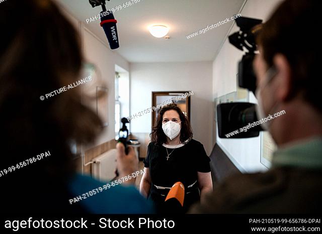 19 May 2021, North Rhine-Westphalia, Kleve: Defence lawyer Melanie Jüde (M) gives an interview in the regional court before the start of the trial for taking...