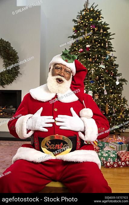 A jolly Santa Claus Ho-ho-hoing and laughing