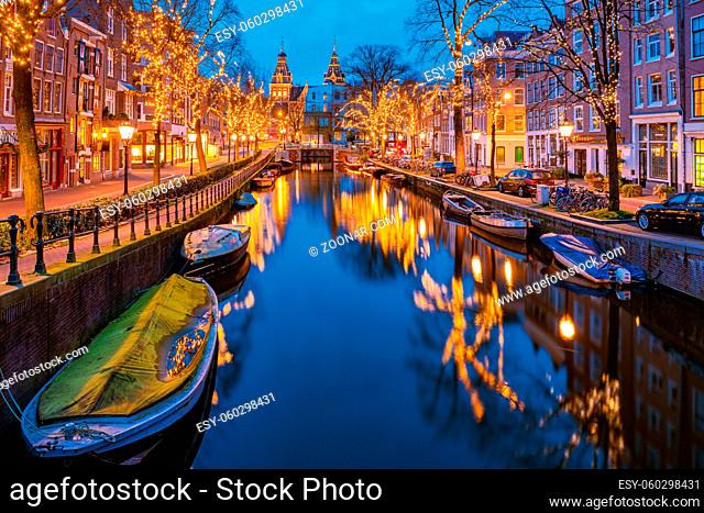 Amsterdam Netherlands canals with Christmas lights during December, canal historical center of Amsterdam at night. Europe