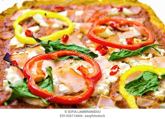 Rectangular 3 in 1 oven baked pizza topped with halloumi, cottage, mozzarella cheese, spinach, turkey, ham, red and yellow peppers, chili